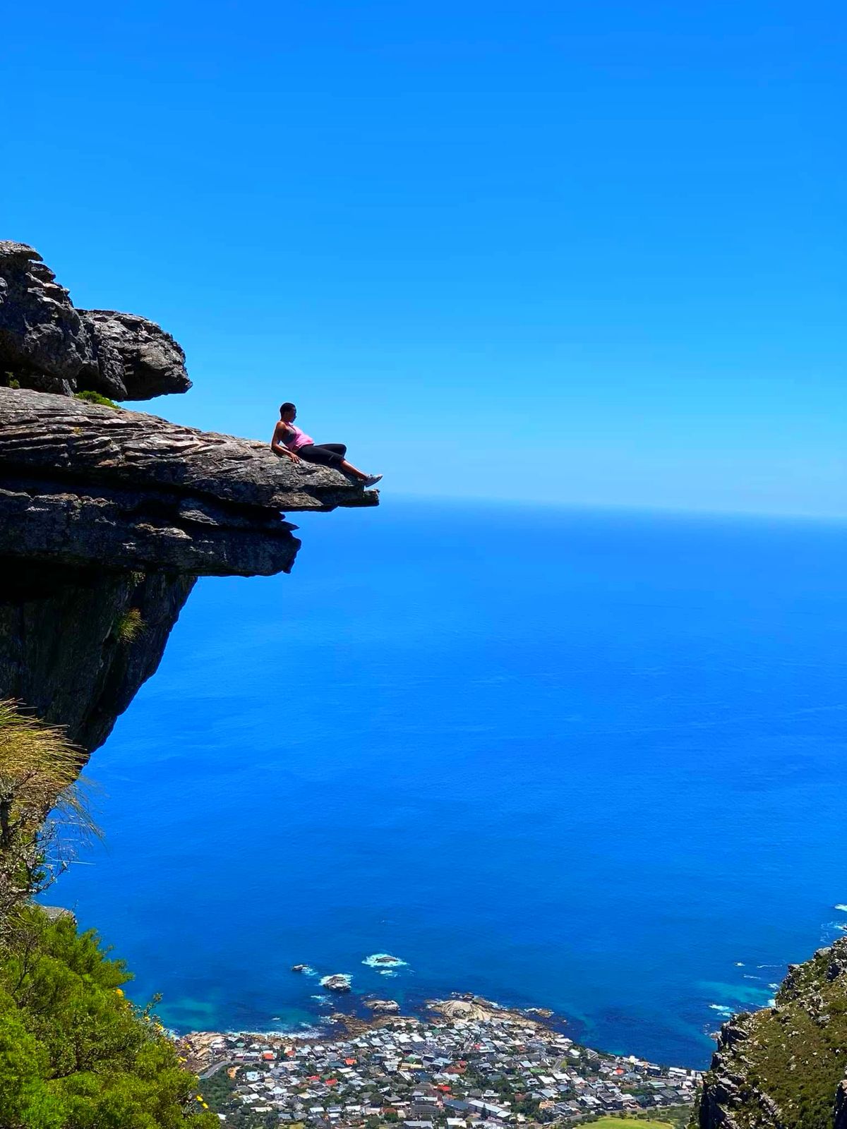 Relaxing on a cliff edge above the ocean