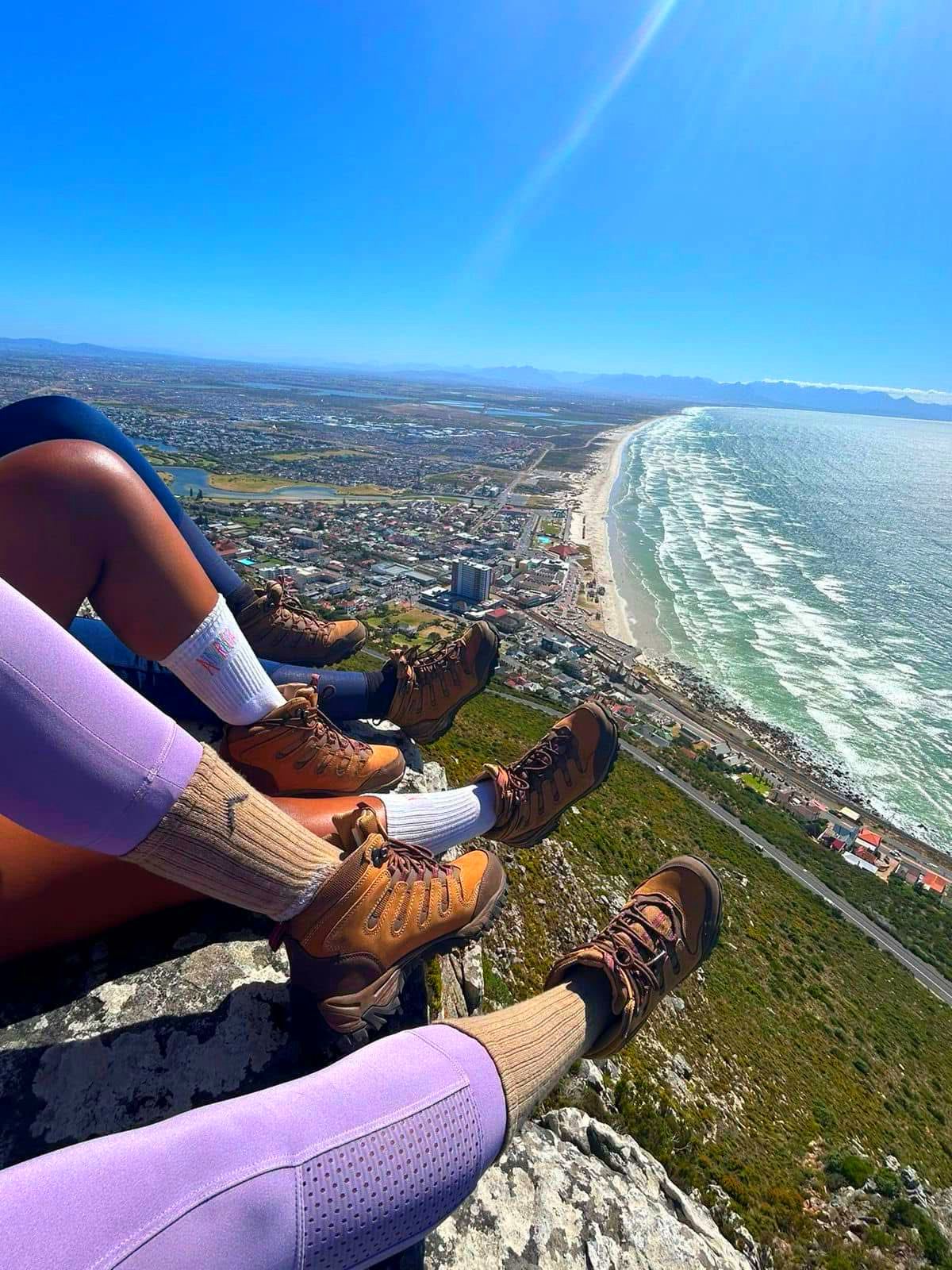 Hiking boots overlooking Muizenberg coastline