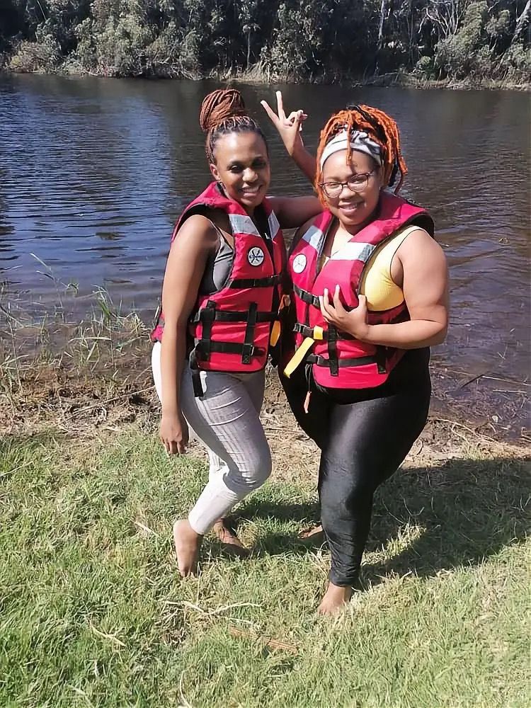 Two friends ready for kayaking in life jackets